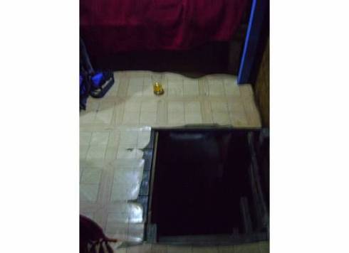 the hole i climbed to my bed (with the red blanket) note the beer on the floor